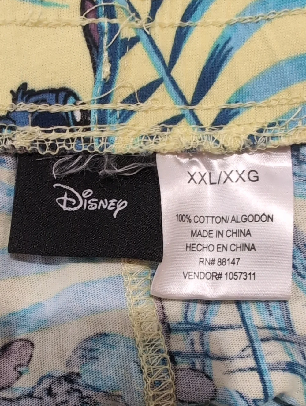 Disney Men's Yellow Stitch Shorts with Blue Tropical Leaf Print